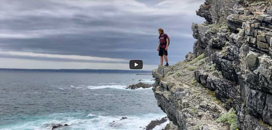 Hiker on rocky coast in Garden Route